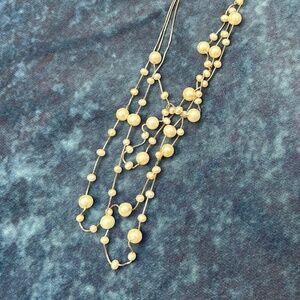 Three-strand likely pearl station necklace